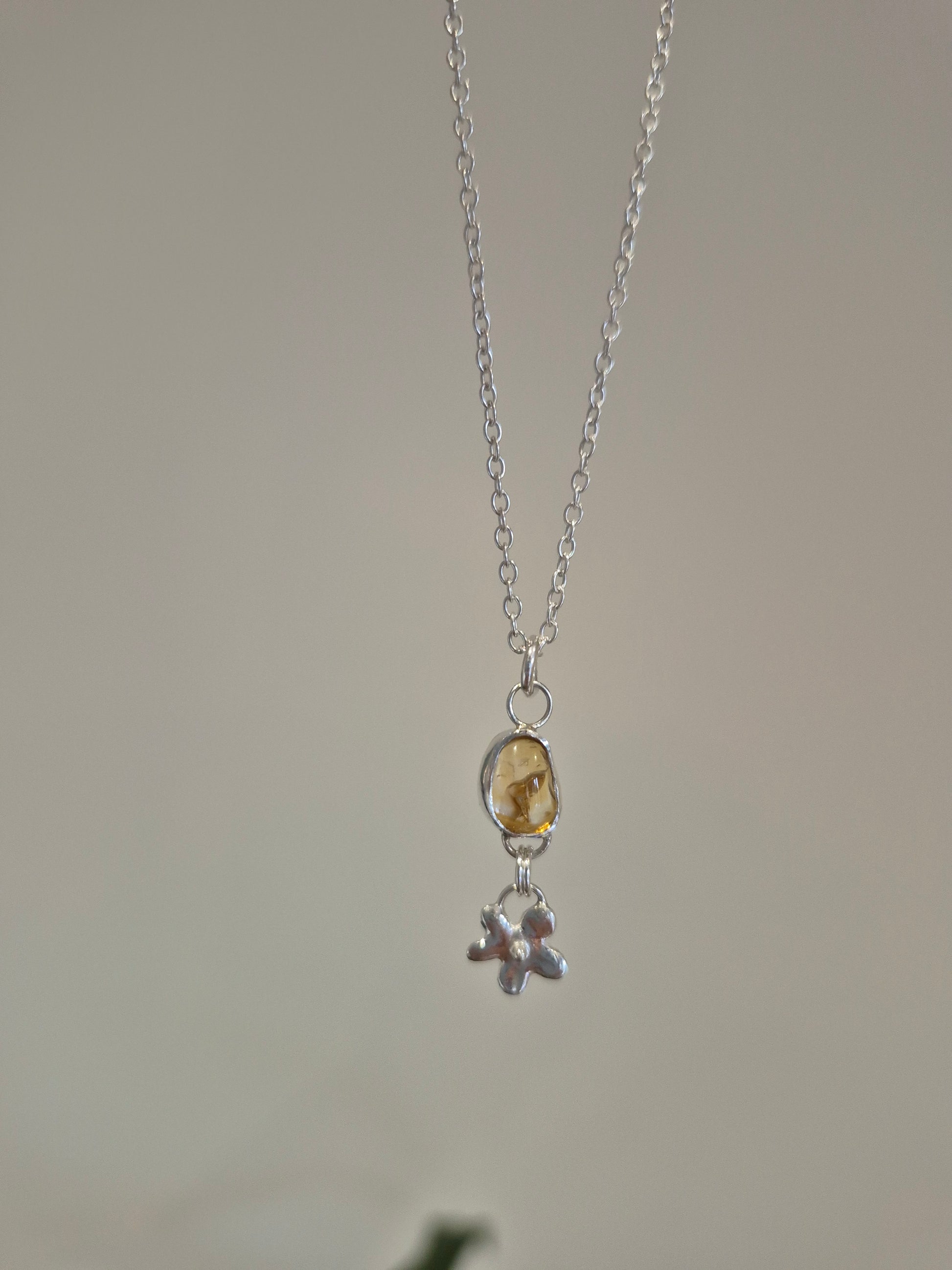 Necklace with a pendant on a plain background