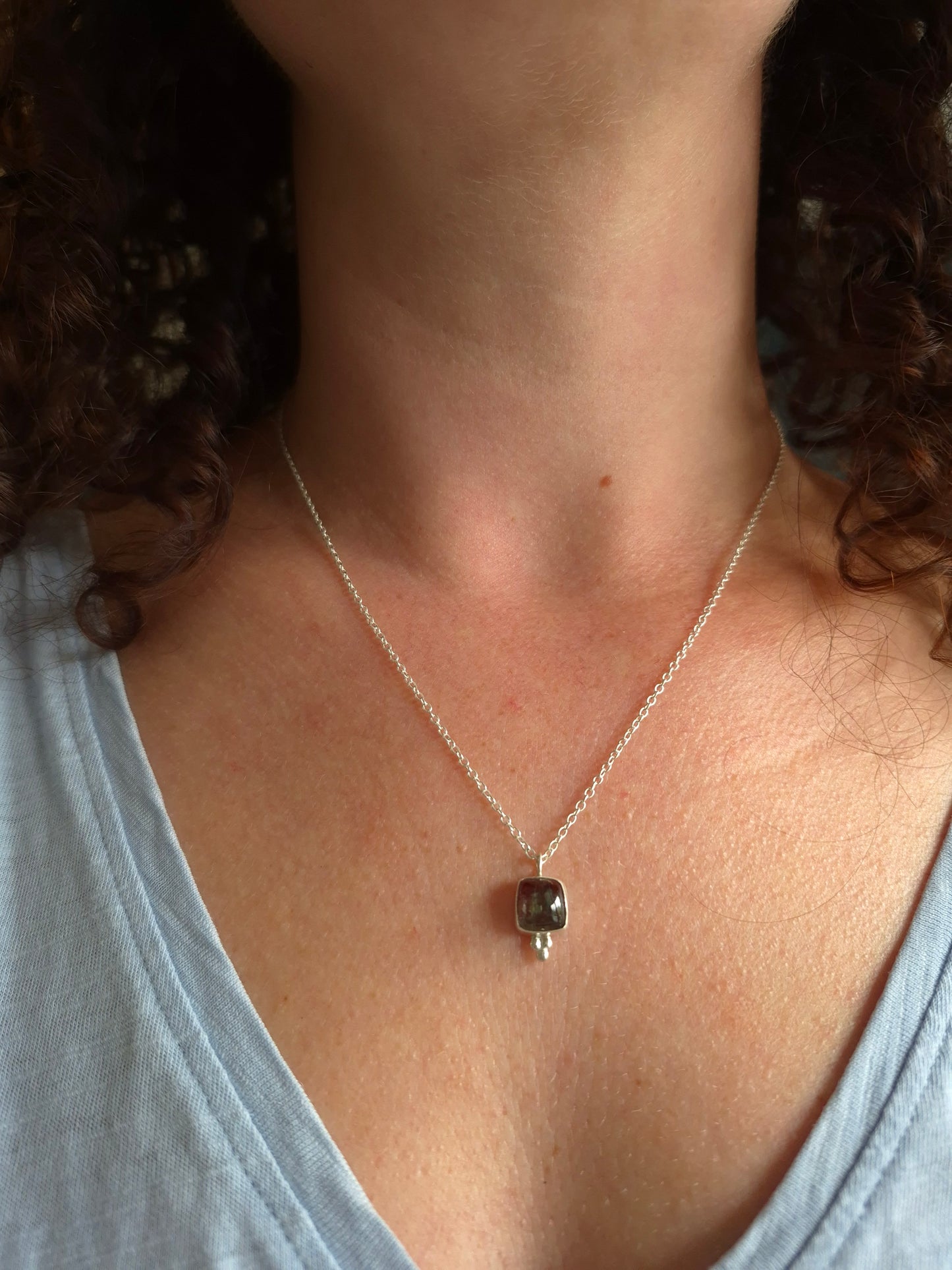Necklace with a pendant on a person's neck