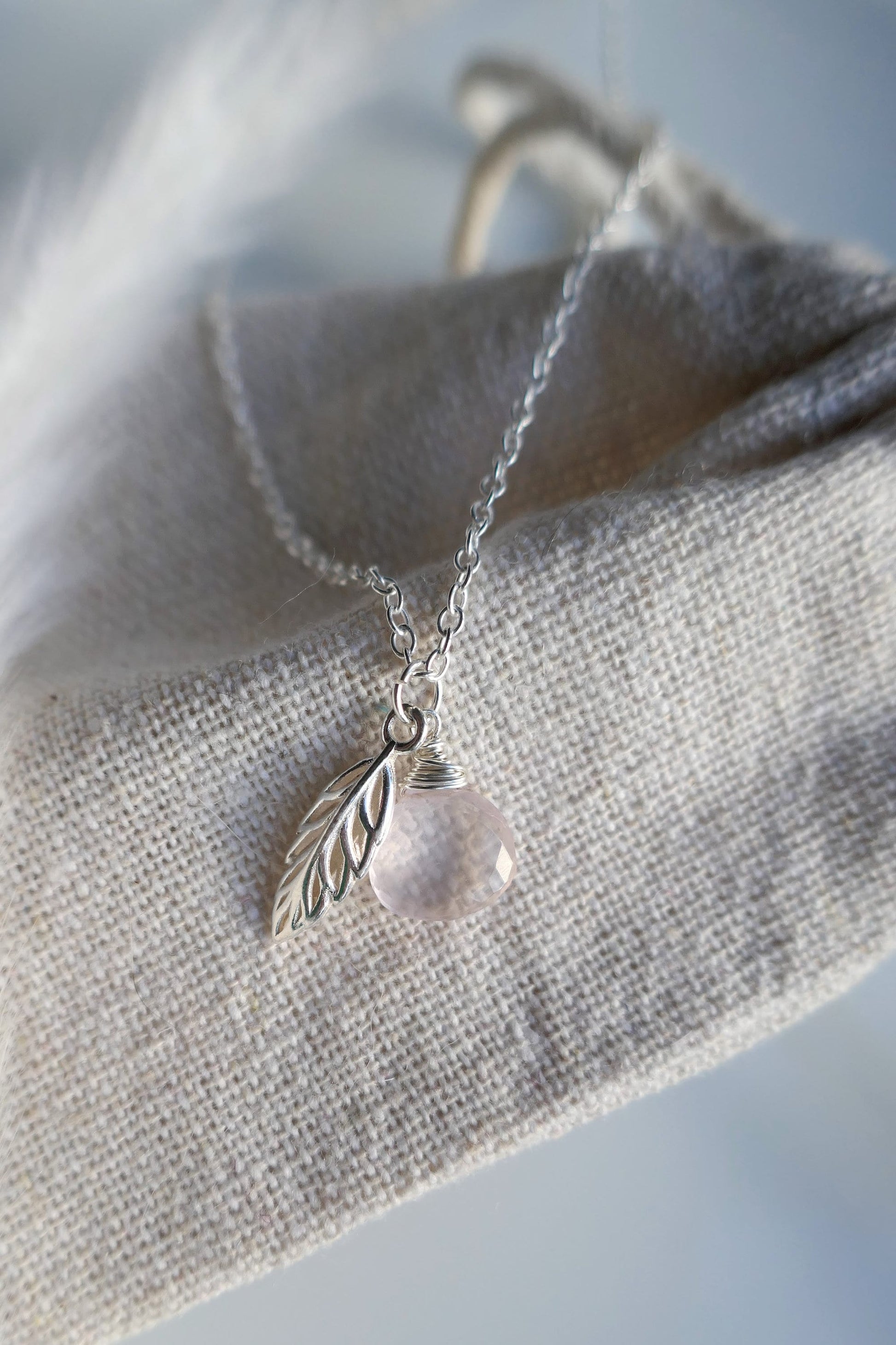 Sterling silver necklace with rose quartz gemstone and leaf pendant